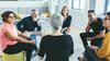 a group of people talking in a circle